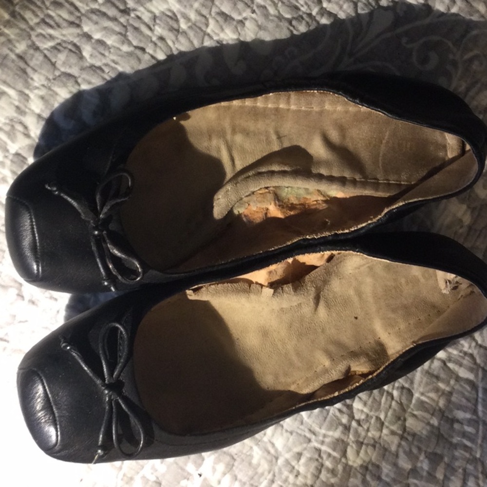 Well worn black ballet flat